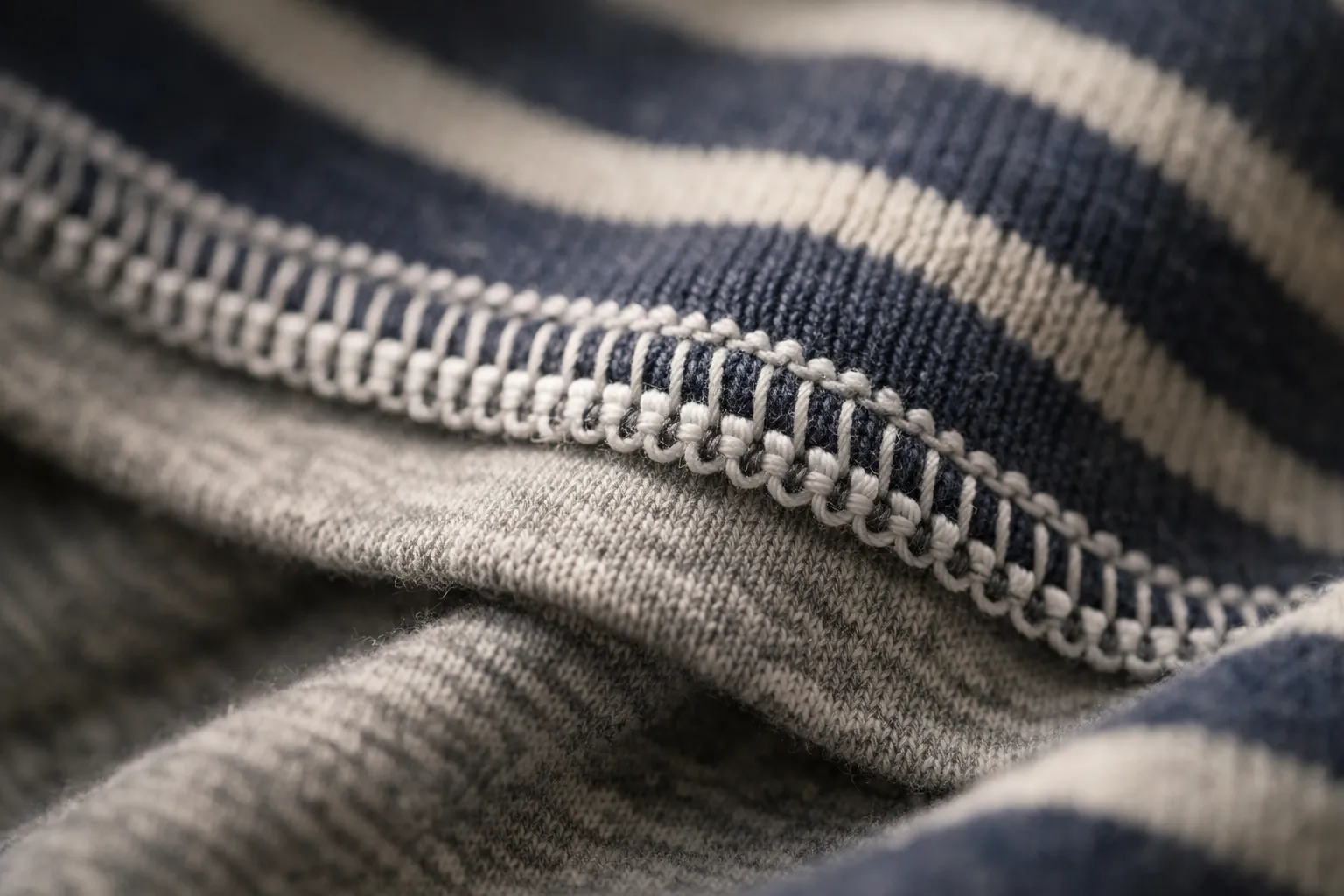 A four-thread overlock seam inside a striped knit T-shirt